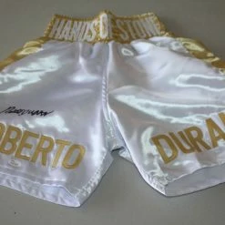 Iconsofboxing.com TOP FIGHTERS ROBERTO DURAN SIGNED GOLD BOXING TRUNKS "HAND OF STONE" JSA WITNESS PANAMA